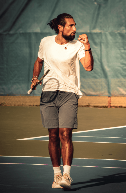 male tennis player celebrating after a point